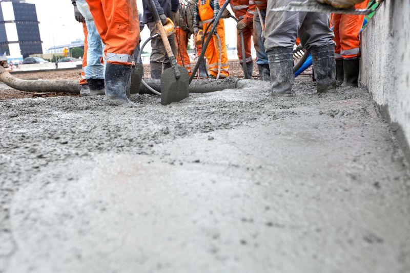men at work pouring concrete